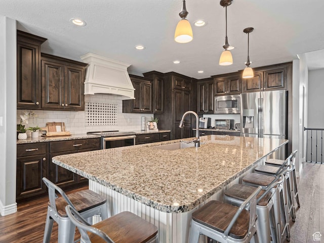 3552 S 5250 W Unit 13, Hooper, UT 84315 - kitchen with stainless steel appliances, premium range hood, dark wood finished floors, dark brown cabinetry, and recessed lighting