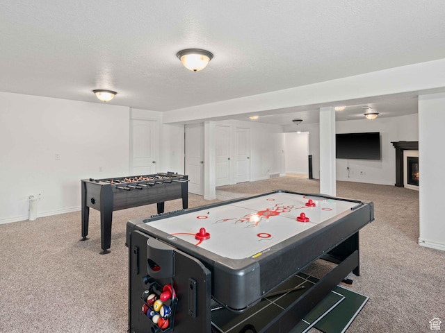 3552 S 5250 W Unit 13, Hooper, UT 84315 - recreation room featuring light colored carpet, a textured ceiling, and a glass covered fireplace