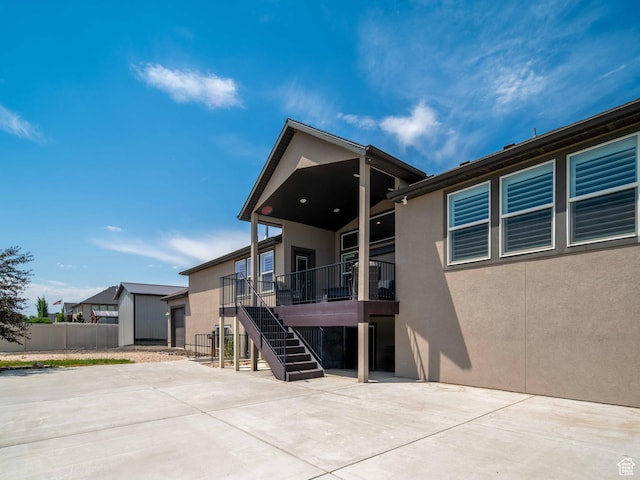 3552 S 5250 W Unit 13, Hooper, UT 84315 - rear view of property with a patio area, stucco siding, and stairway