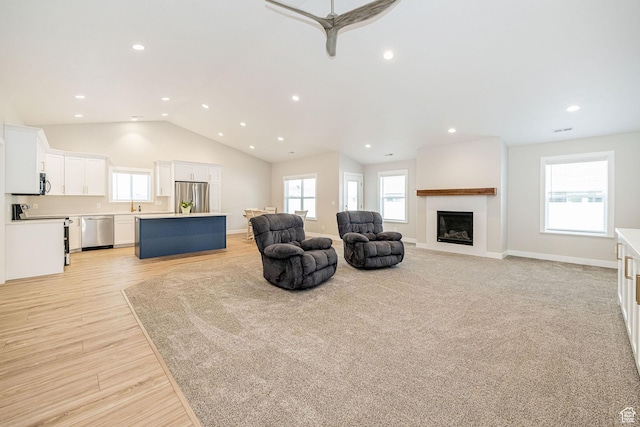 318 E 290 N, Preston, ID 83263 - living area with a fireplace, vaulted ceiling, recessed lighting, ceiling fan, and light wood-style floors