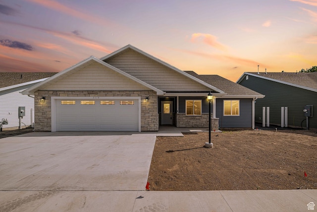 318 E 290 N, Preston, ID 83263 - view of front of home with concrete driveway, stone siding, and an attached garage
