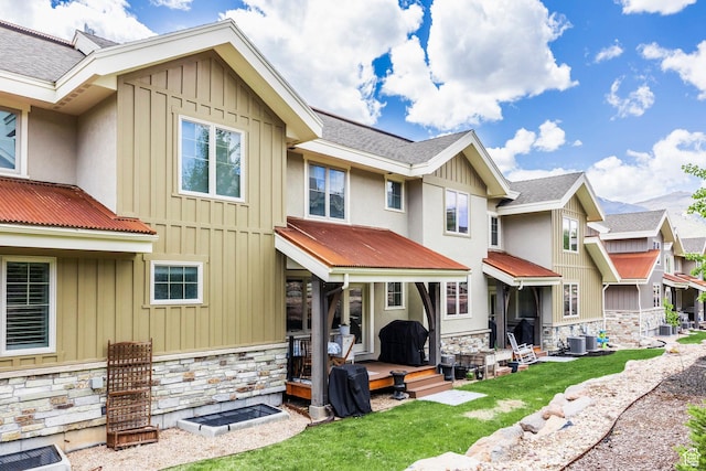 538 W Heritage Way, Heber City, UT 84032 - rear view of house with board and batten siding, stone siding, a lawn, and a metal roof
