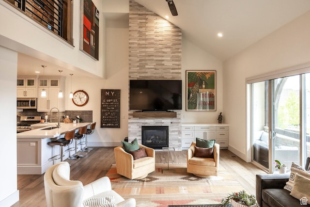 538 W Heritage Way, Heber City, UT 84032 - living room featuring high vaulted ceiling, light wood finished floors, a fireplace, and recessed lighting