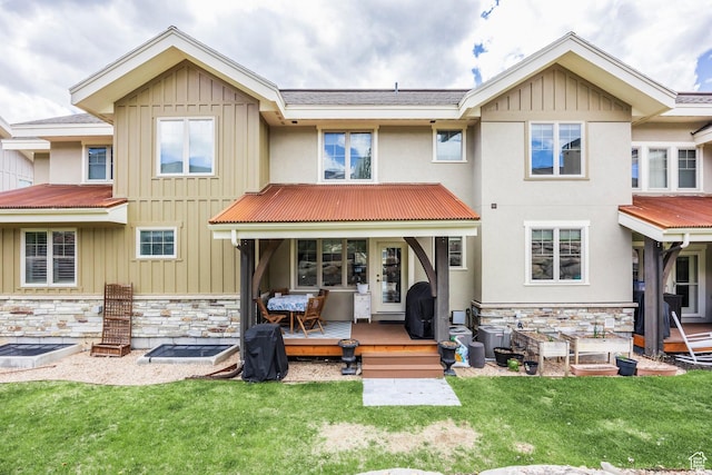 538 W Heritage Way, Heber City, UT 84032 - back of property featuring stone siding, a lawn, a wooden deck, and a metal roof