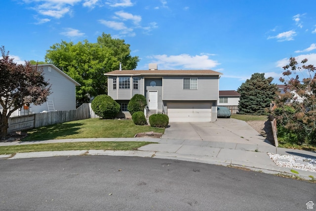 6446 S 4160 W, Taylorsville, UT 84129 - raised ranch featuring a garage, driveway, and a chimney