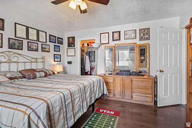6446 S 4160 W, Taylorsville, UT 84129 - bedroom with a textured ceiling, a walk in closet, dark wood-type flooring, a closet, and ceiling fan