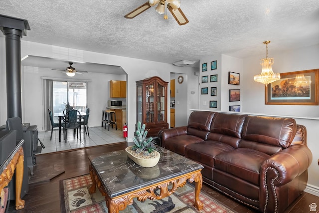 6446 S 4160 W, Taylorsville, UT 84129 - living area featuring ceiling fan, wood finished floors, a wood stove, and a textured ceiling