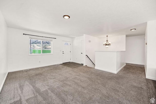 496 S 1600 E, Hyrum, UT 84319 - unfurnished room featuring a chandelier and dark carpet