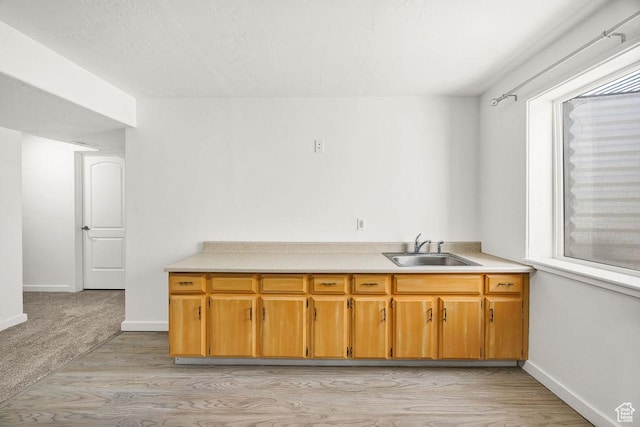 496 S 1600 E, Hyrum, UT 84319 - kitchen with light wood finished floors, light countertops, and brown cabinets