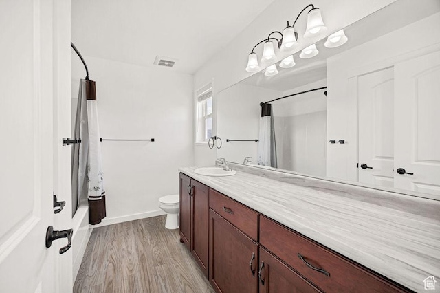 496 S 1600 E, Hyrum, UT 84319 - bathroom featuring vanity, wood finished floors, and shower / bathtub combination with curtain