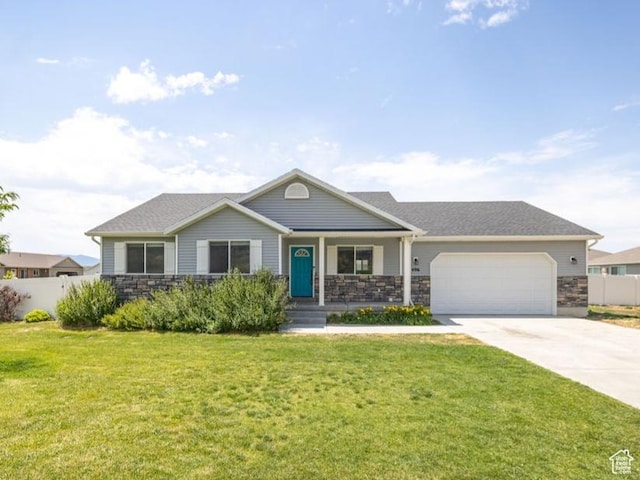 496 S 1600 E, Hyrum, UT 84319 - view of front of property featuring stone siding, an attached garage, driveway, and covered porch