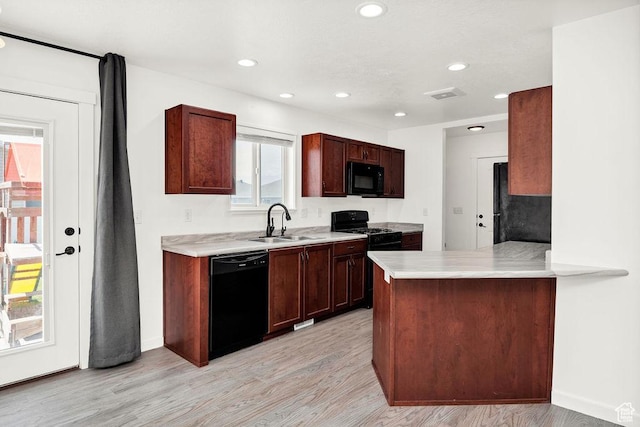 496 S 1600 E, Hyrum, UT 84319 - kitchen with black appliances, light countertops, light wood-style flooring, recessed lighting, and a peninsula