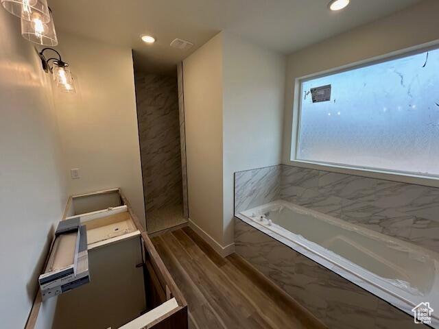1966 W 4750 N Unit 7, Enoch, UT 84721 - bathroom with a garden tub, vanity, recessed lighting, and wood finished floors