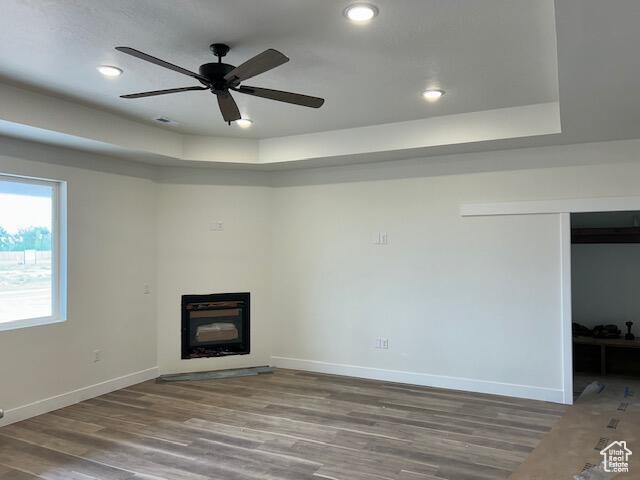 1966 W 4750 N Unit 7, Enoch, UT 84721 - unfurnished living room with a glass covered fireplace, ceiling fan, wood finished floors, and recessed lighting