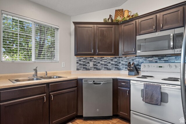 141 W Suncrest Ln, Saratoga Springs, UT 84045 - kitchen featuring stainless steel appliances, dark brown cabinetry, light countertops, backsplash, and light wood-type flooring