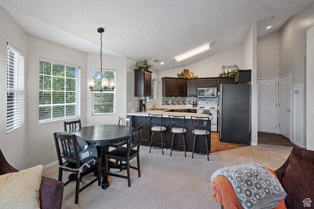 141 W Suncrest Ln, Saratoga Springs, UT 84045 - dining space featuring a chandelier, vaulted ceiling, light carpet, and recessed lighting