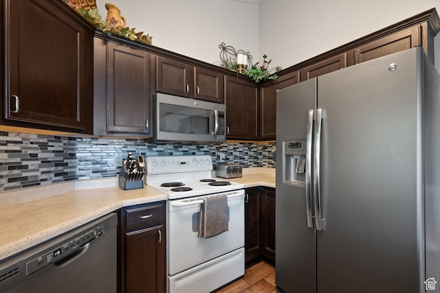 141 W Suncrest Ln, Saratoga Springs, UT 84045 - kitchen featuring appliances with stainless steel finishes, dark brown cabinets, decorative backsplash, and light countertops