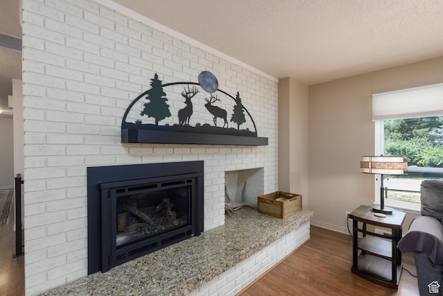 3250 N River Dr, Eden, UT 84310 - detailed view of a textured ceiling, wood finished floors, and a brick fireplace