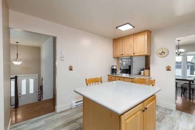 3250 N River Dr, Eden, UT 84310 - kitchen featuring light wood-type flooring, light brown cabinets, light countertops, and a center island