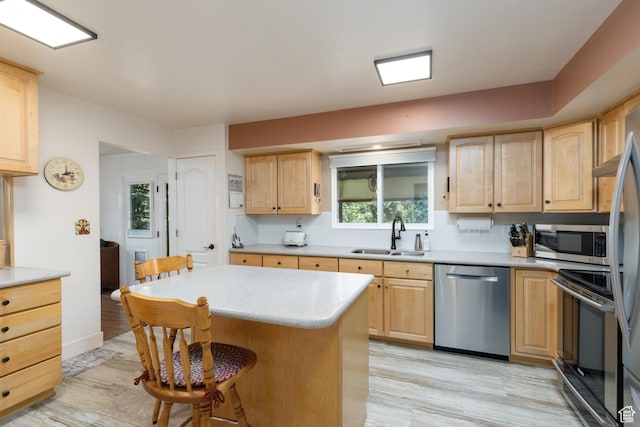 3250 N River Dr, Eden, UT 84310 - kitchen with stainless steel appliances, light brown cabinetry, a kitchen bar, and light countertops