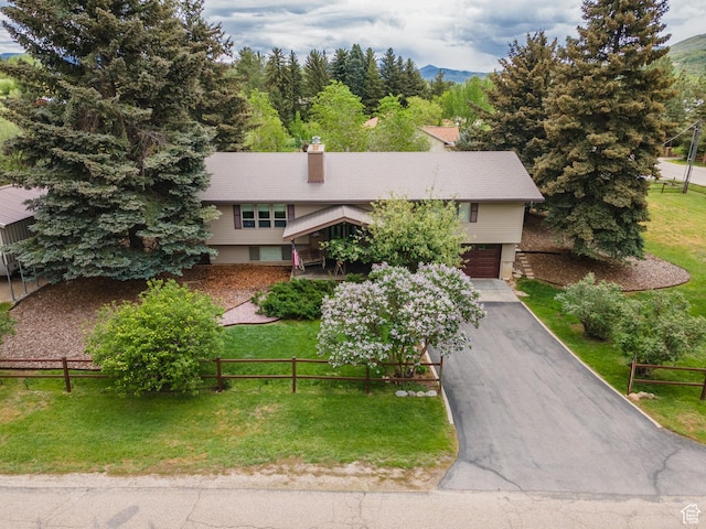 3250 N River Dr, Eden, UT 84310 - view of front of property featuring an attached garage, a chimney, driveway, and a mountain view