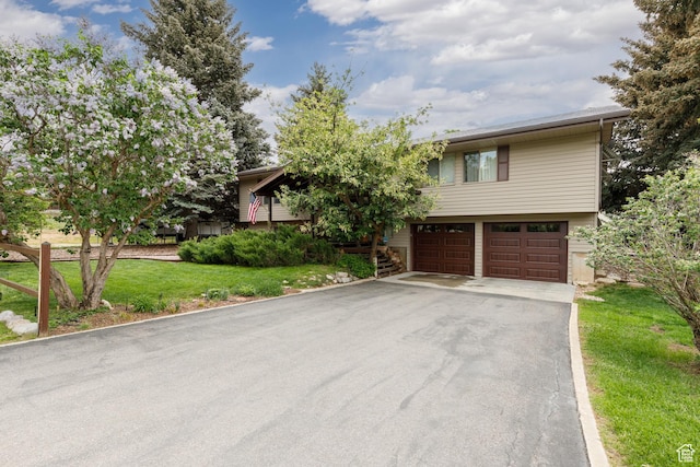 3250 N River Dr, Eden, UT 84310 - view of front of property featuring driveway, a garage, and a front yard
