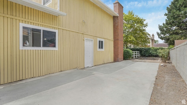 7488 S Blackfriar Cir, West Jordan, UT 84084 - view of property exterior with a patio and a chimney