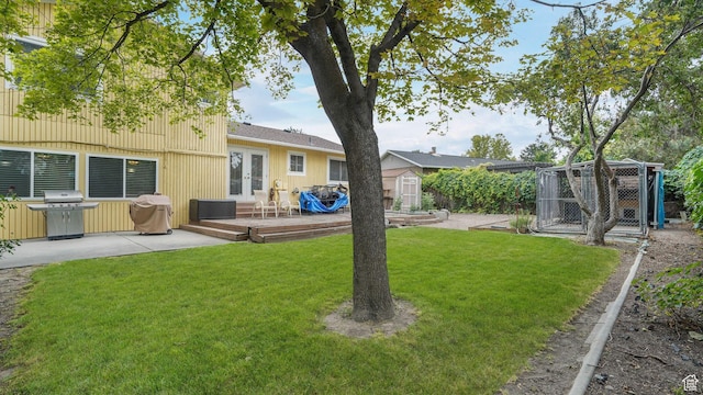 7488 S Blackfriar Cir, West Jordan, UT 84084 - view of green lawn featuring french doors, a shed, and a deck