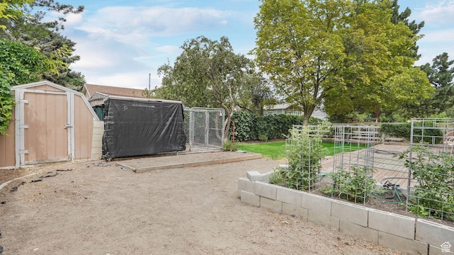 7488 S Blackfriar Cir, West Jordan, UT 84084 - view of yard featuring a storage shed and a garden