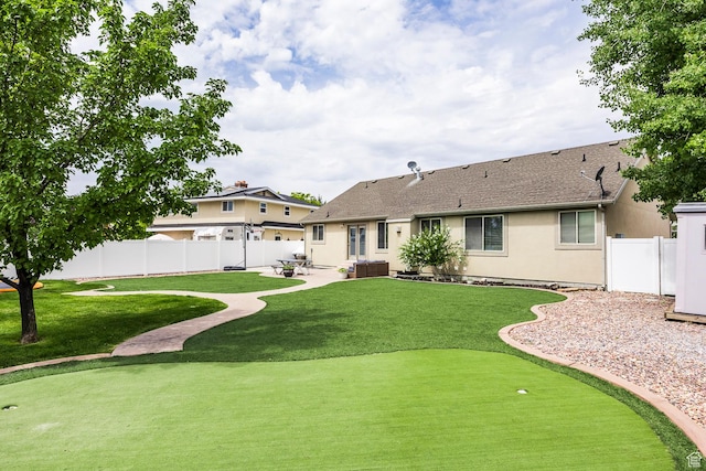 9768 N 5520 W, Highland, UT 84003 - back of property with an area to practice putting, a patio, stucco siding, a fenced backyard, and a shingled roof