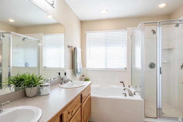 9768 N 5520 W, Highland, UT 84003 - bathroom with a shower stall, healthy amount of natural light, double vanity, a garden tub, and recessed lighting