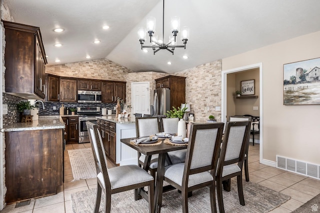 9768 N 5520 W, Highland, UT 84003 - dining area featuring vaulted ceiling, light tile patterned floors, and a chandelier