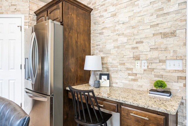 9768 N 5520 W, Highland, UT 84003 - kitchen featuring stainless steel fridge, light stone countertops, and dark brown cabinetry