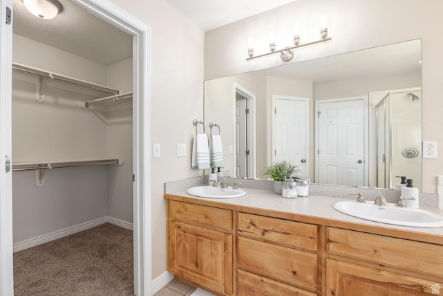 9768 N 5520 W, Highland, UT 84003 - bathroom featuring double vanity, a shower stall, and a walk in closet