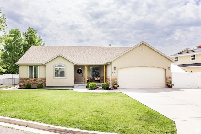 9768 N 5520 W, Highland, UT 84003 - view of front of property featuring stone siding, stucco siding, driveway, an attached garage, and a porch