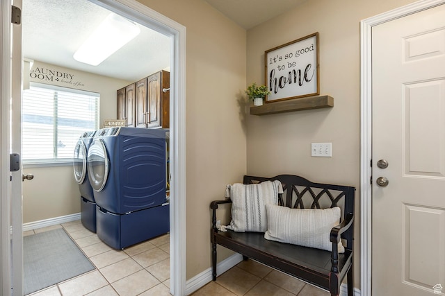 9768 N 5520 W, Highland, UT 84003 - laundry area featuring washing machine and dryer, cabinet space, and light tile patterned floors