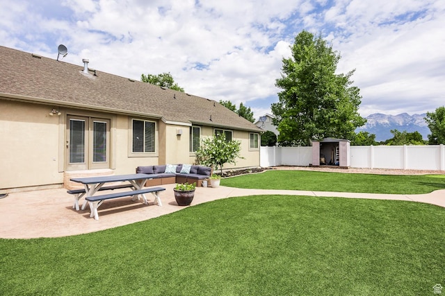 9768 N 5520 W, Highland, UT 84003 - fenced backyard with a storage unit, a patio, a mountain view, and outdoor lounge area