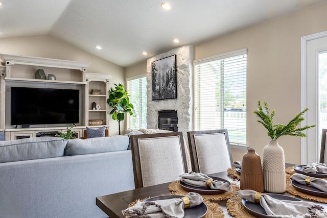 9768 N 5520 W, Highland, UT 84003 - living room with vaulted ceiling, a stone fireplace, plenty of natural light, and recessed lighting