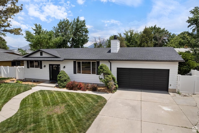 9499 S 220 E, Sandy, UT 84070 - single story home with concrete driveway, an attached garage, a chimney, and roof with shingles