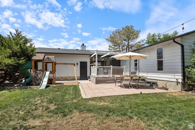 9499 S 220 E, Sandy, UT 84070 - back of property featuring a patio, a playground, a garage, a lawn, and a chimney