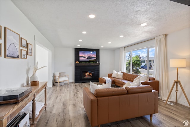 9499 S 220 E, Sandy, UT 84070 - living room with wood finished floors, recessed lighting, a large fireplace, and a textured ceiling