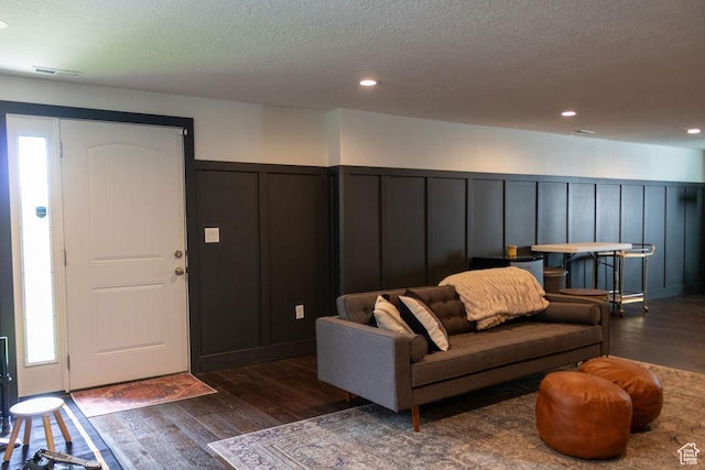 4373 N Foxtrail Dr, Lehi, UT 84043 - living room with a decorative wall, dark wood-style flooring, a wainscoted wall, a textured ceiling, and recessed lighting