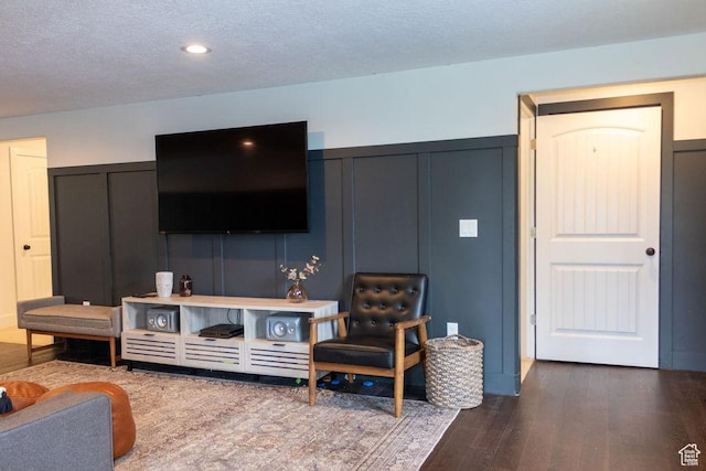 4373 N Foxtrail Dr, Lehi, UT 84043 - living room featuring a decorative wall, dark wood-type flooring, wainscoting, and a textured ceiling