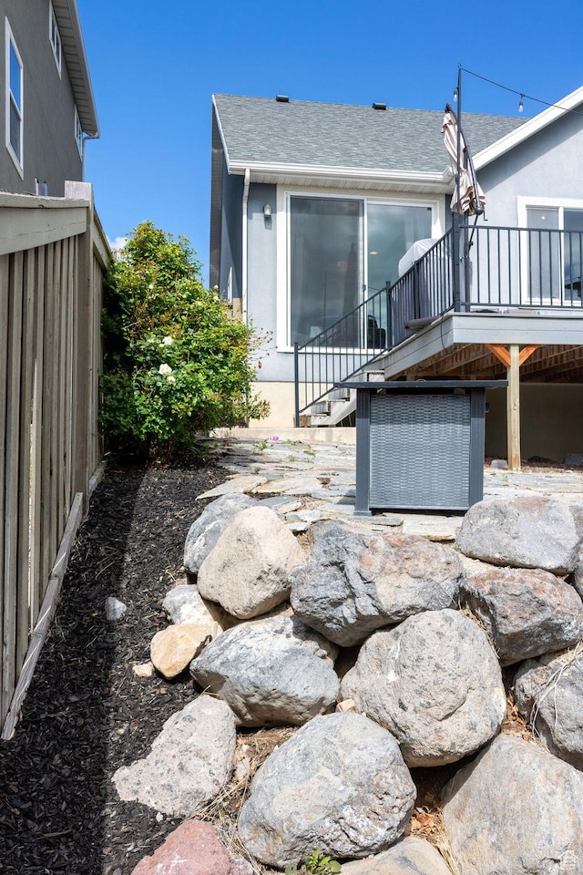 4373 N Foxtrail Dr, Lehi, UT 84043 - back of house with a shingled roof, a deck, stairs, and stucco siding