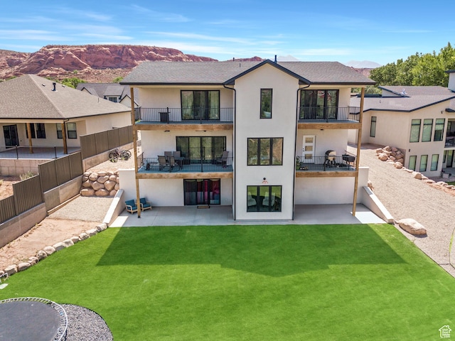 3317 S Watchman Trl, Moab, UT 84532 - back of property with a balcony, stucco siding, a patio, and a mountain view