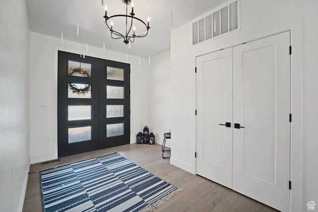 3317 S Watchman Trl, Moab, UT 84532 - entrance foyer with a chandelier, wood finished floors, and french doors