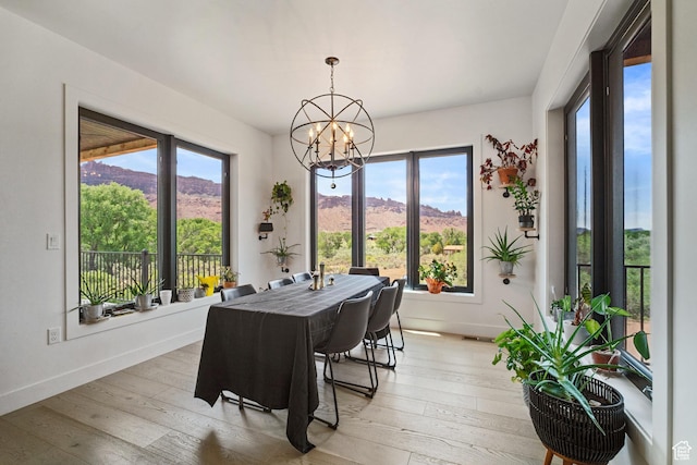 3317 S Watchman Trl, Moab, UT 84532 - dining area with a chandelier, light wood finished floors, and a mountain view