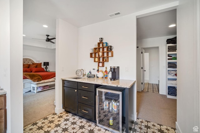 3317 S Watchman Trl, Moab, UT 84532 - indoor dry bar featuring wine cooler, light colored carpet, light flooring, ceiling fan, and recessed lighting