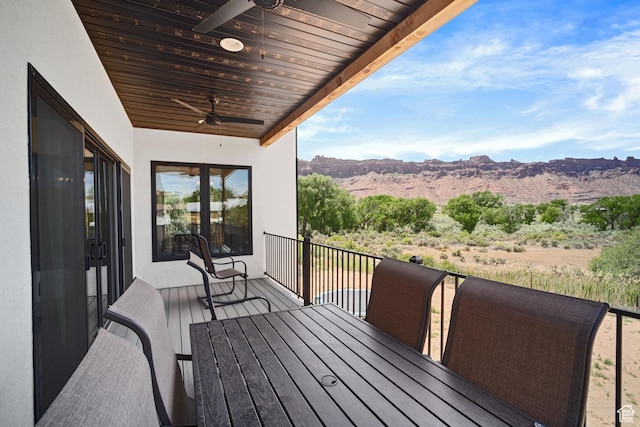 3317 S Watchman Trl, Moab, UT 84532 - wooden deck featuring a ceiling fan, a mountain view, and outdoor dining space