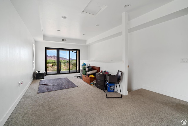 3317 S Watchman Trl, Moab, UT 84532 - unfurnished living room featuring carpet flooring, attic access, and a raised ceiling